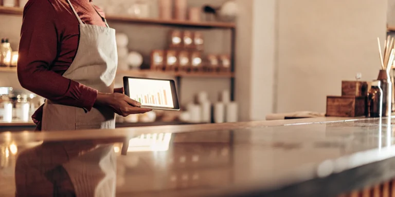 Business owner reviews MCA data on tablet.