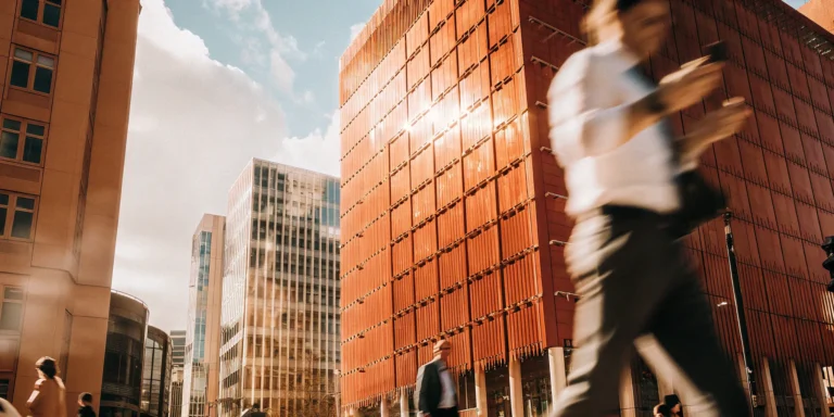 Business professionals navigate a modern city. Same day funding empowers their ventures.