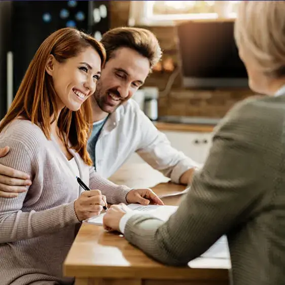 Business advisor discussing documents with a couple.