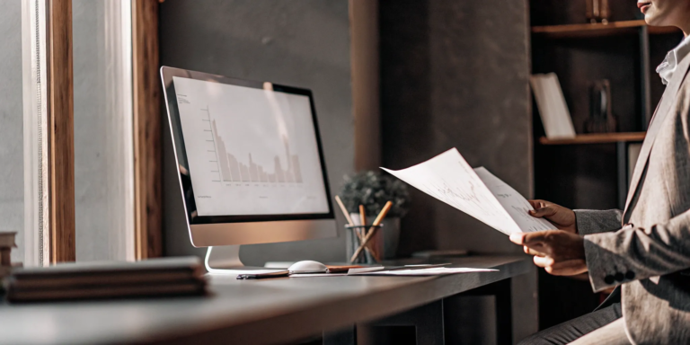 What Is Invoice Non-Recourse Factoring? A Guide 2 A business professional reviewing factoring without recourse data on a computer screen.