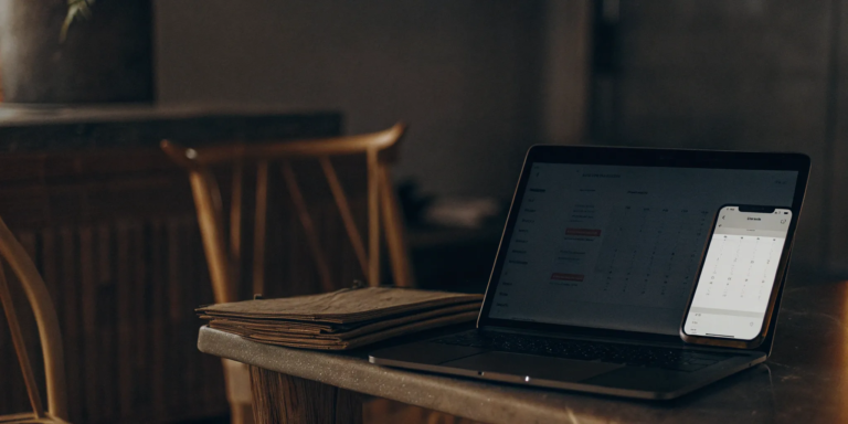 Laptop on a desk showing financial data for a same day EIN loan application.