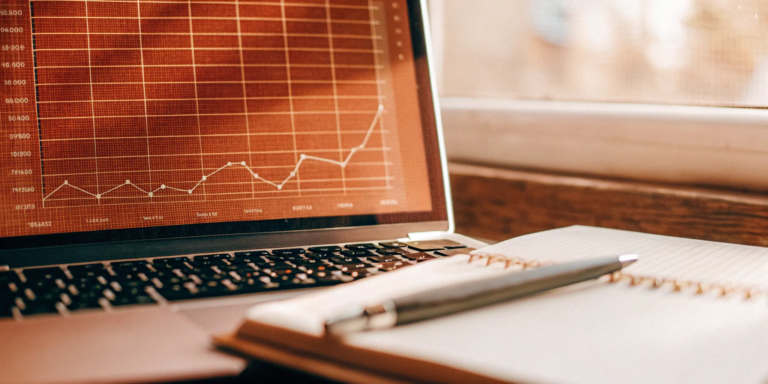Analyzing a business growth chart on a laptop to apply for a small business term loan.