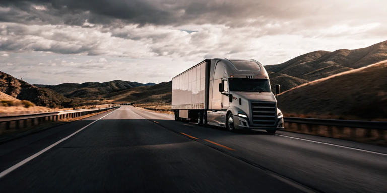 A semi truck on a highway, a guide to the best factoring companies for trucking.