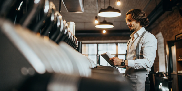 Small business owner reviewing equipment financing documents.