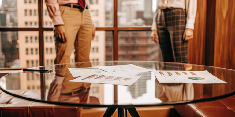 What Is Invoice Factoring for Businesses? A Guide 12 Business professionals analyzing charts with examples of factoring receivables.