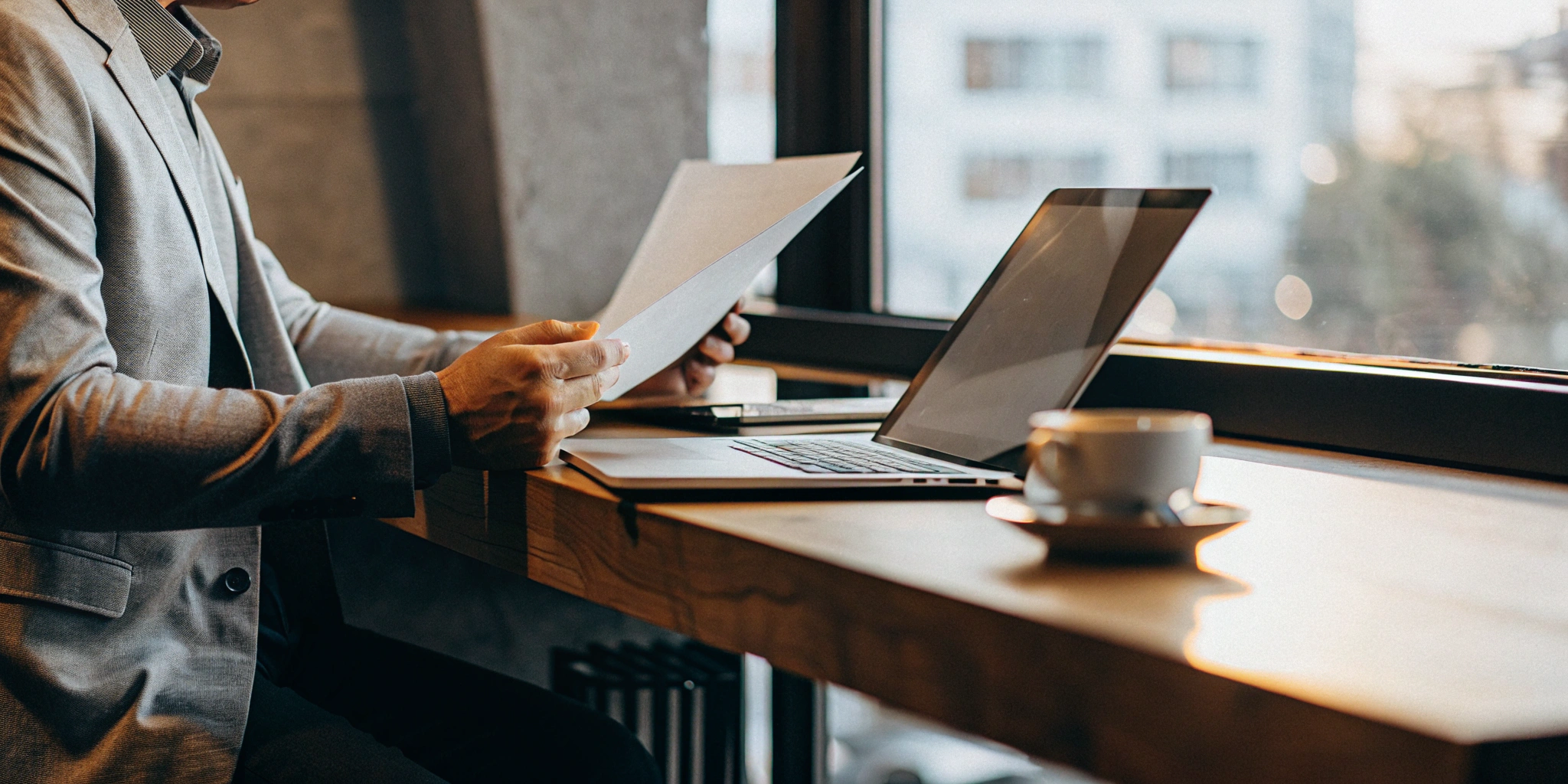 Business owner reviewing documents while applying for a fixed rate business loan online.