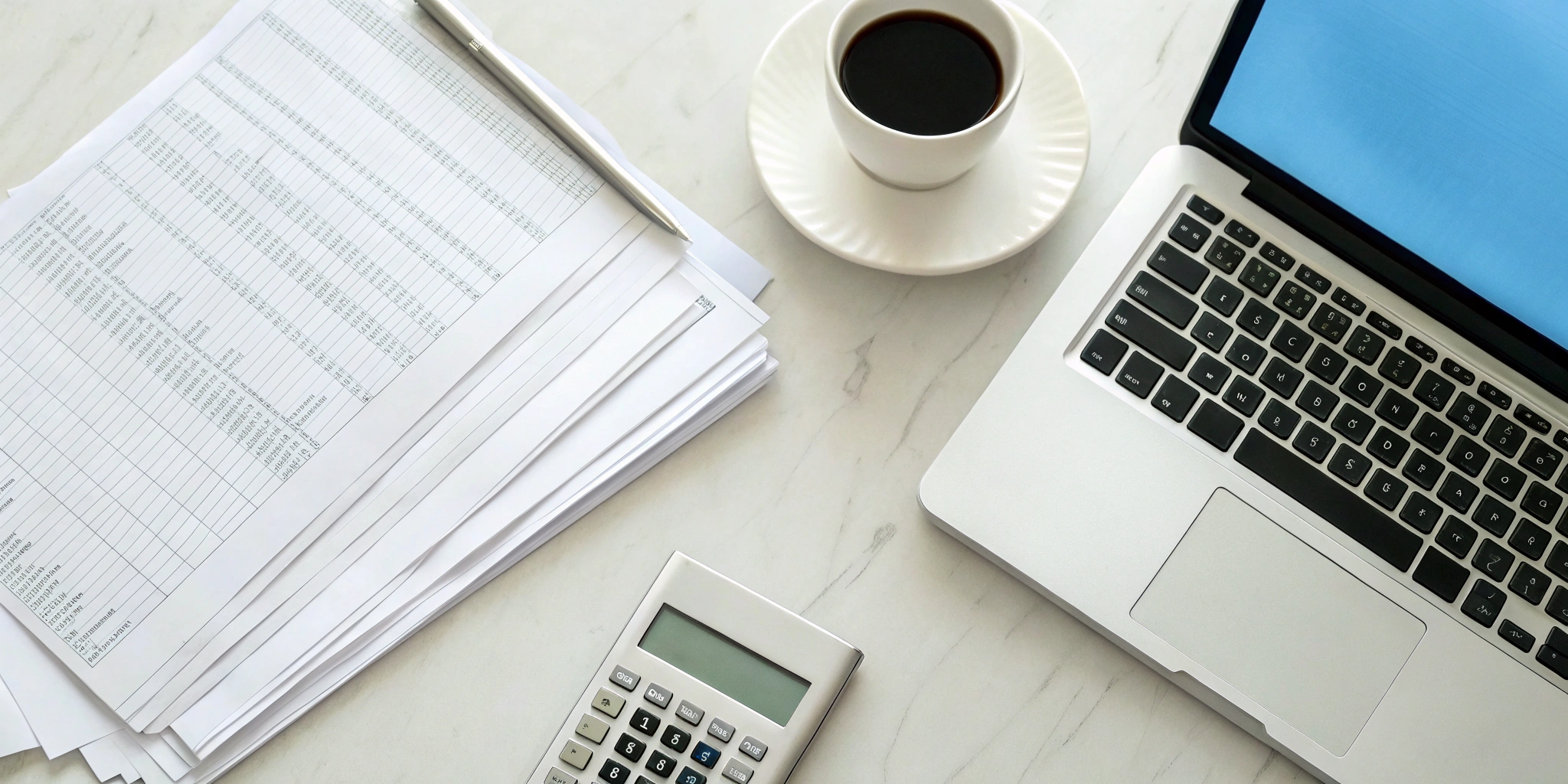 A calculator and paperwork on a desk for a plan to consolidate business debt.