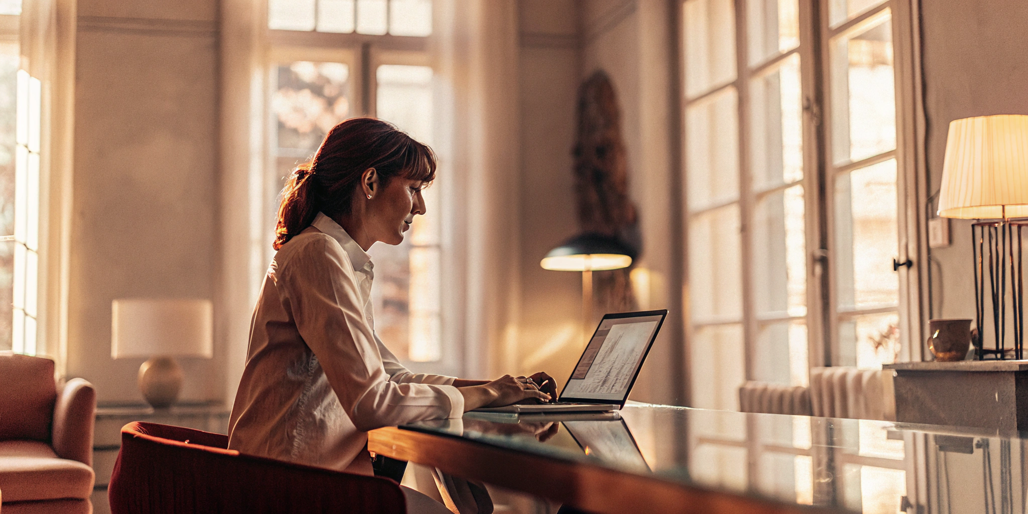 Woman at a laptop researching how to qualify for an unsecured business line of credit.