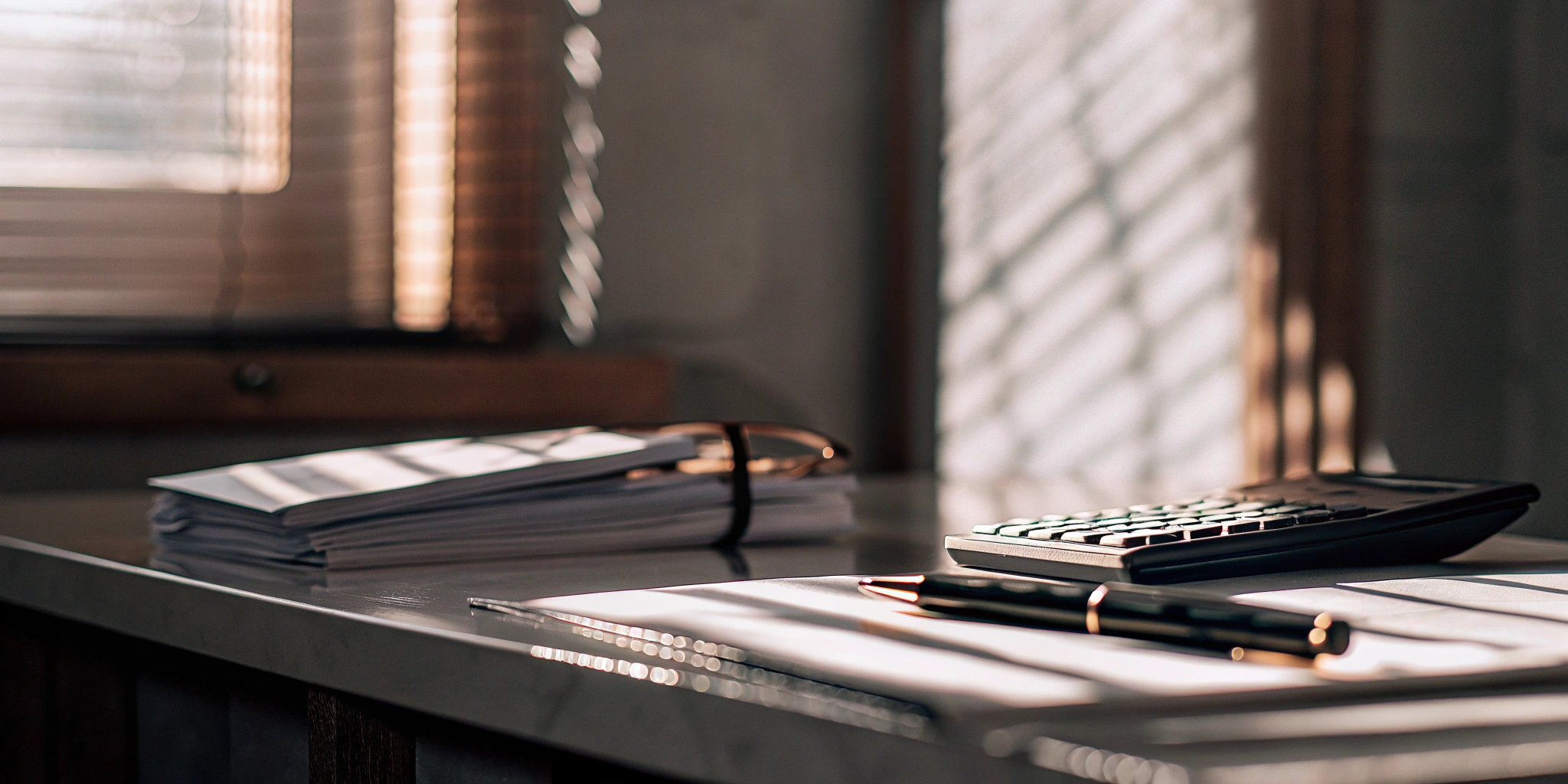 Calculating the true cost of invoice factoring rates and fees with a calculator and documents.