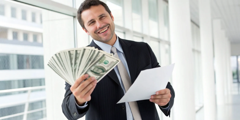 Your Guide to Instant Sales Funding in 3 Steps 11 A man holds cash and a document for his instant business funding approval.