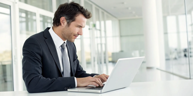 A business owner on a laptop researching same day online loans from a direct lender.